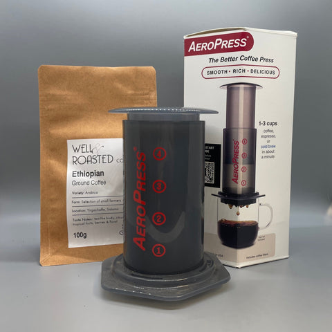 An Aeropress Coffee Maker with a bag of Well Roasted Coffee speciality coffee